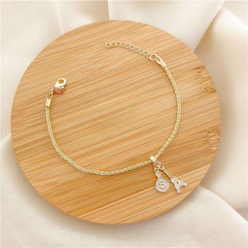 PULSEIRA COM PINGENTES TORRE EIFFEL-SAQUINHO - CRISTAL