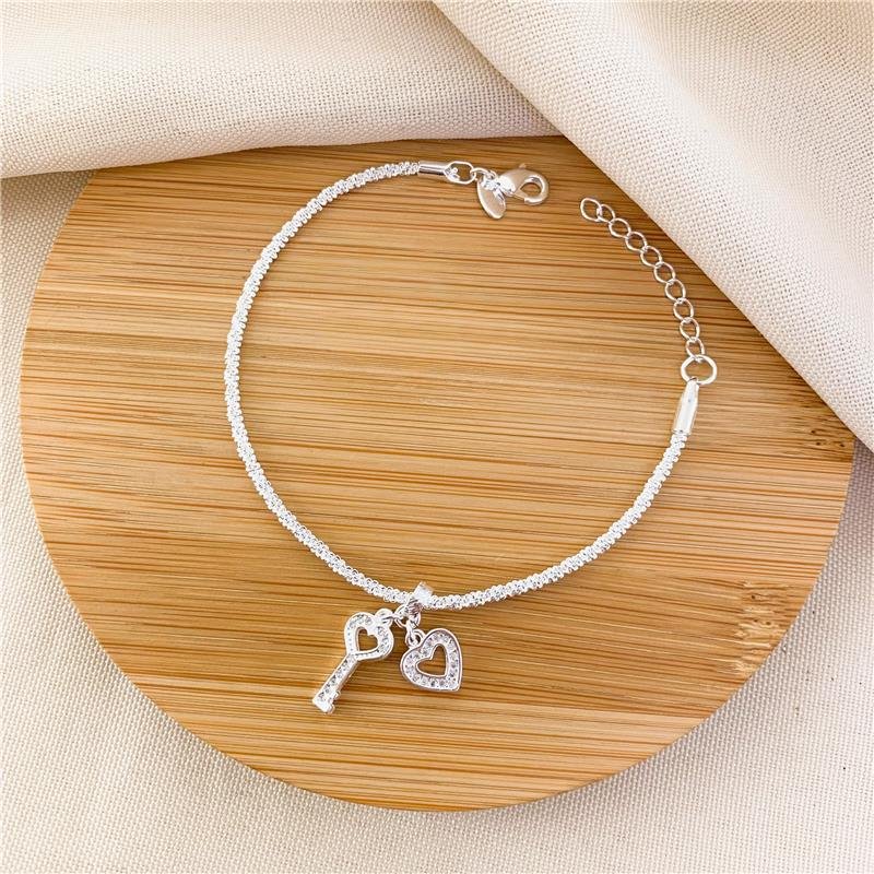 PULSEIRA MEDUSA COM PINGENTES CORAÇÃO E CHAVE - CRISTAL